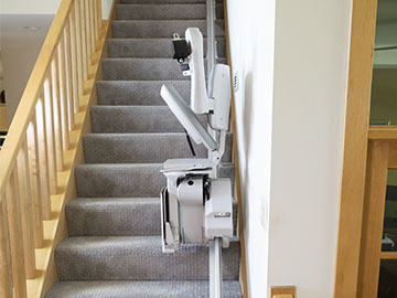 Bruno Elite Stairlift with folded seat, armrests and footrest