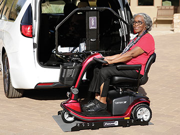 Woman loading scooter onto Bruno Joey platform