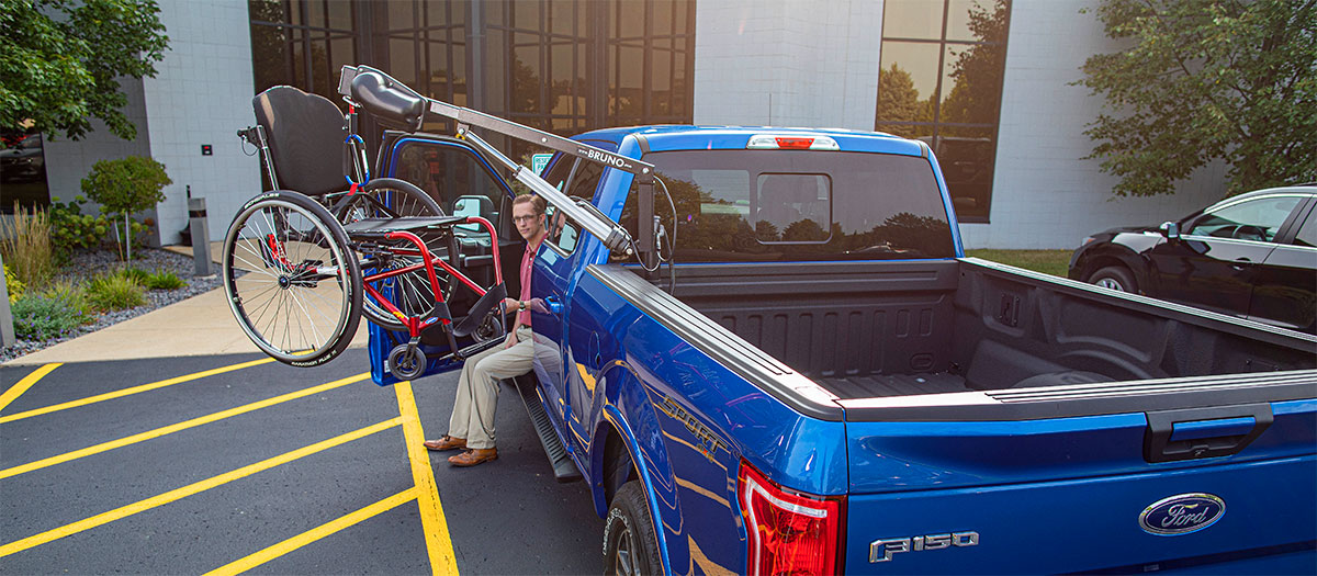 Man using the Bruno Out-Rider on pickup truck